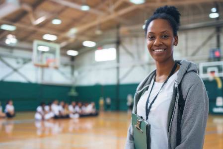 Photo of a female coach on the basketball court.